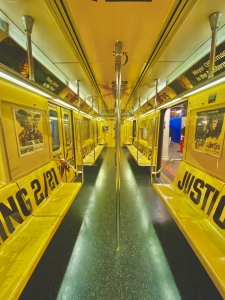 this is the image of empty new york subway car with yellow interior design at times square shuttle line